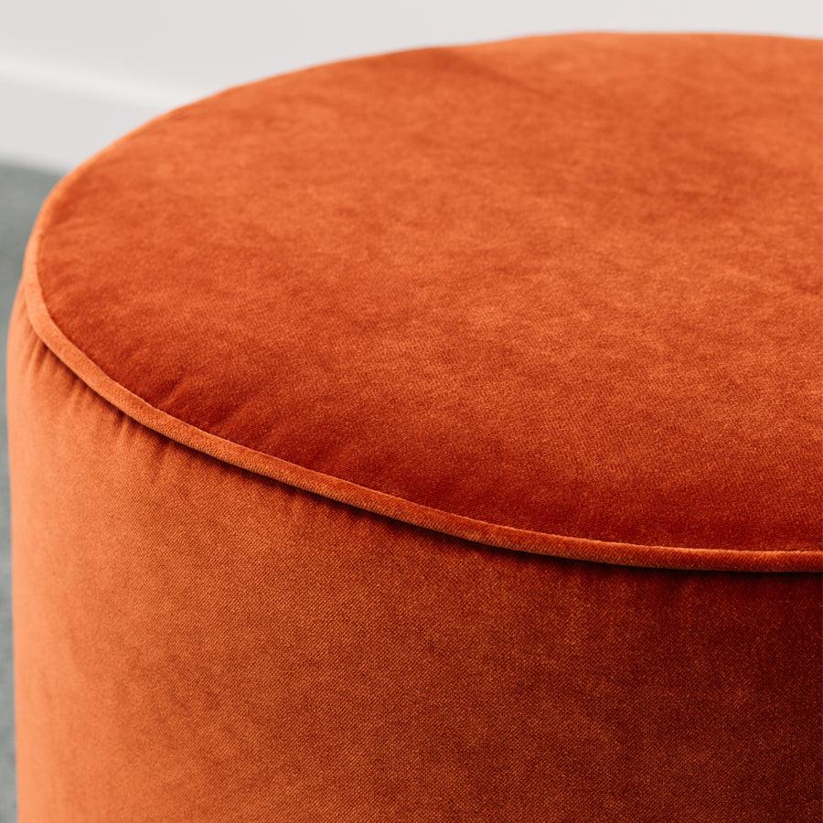 Small round ottoman in theodora paprika