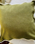 Velveteen scallop edge cushion in olive green