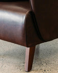 Lily winged leather armchair in settler serge