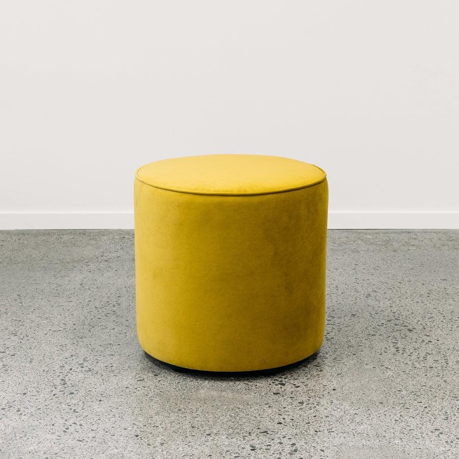 Small round ottoman in plush olive