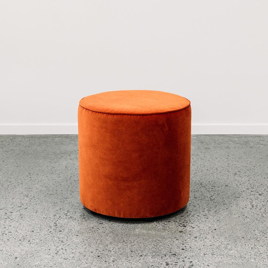 Small round ottoman in theodora paprika