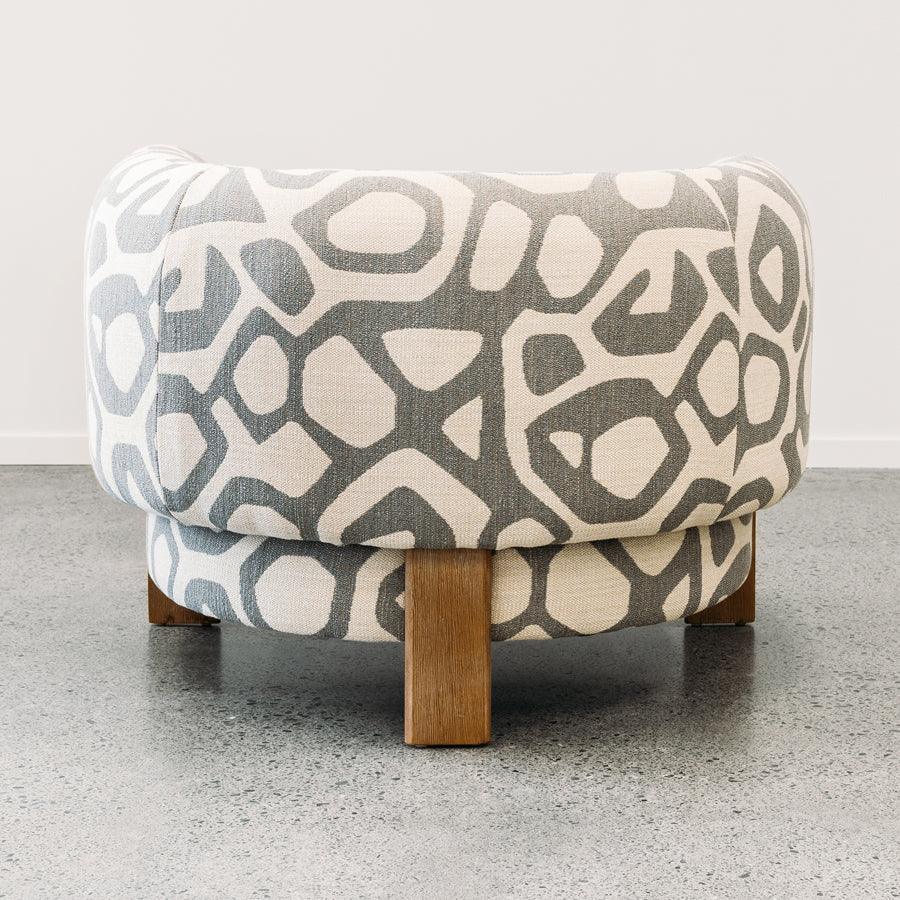 Caleb armchair in atomic stone in a soft geometric pattern

