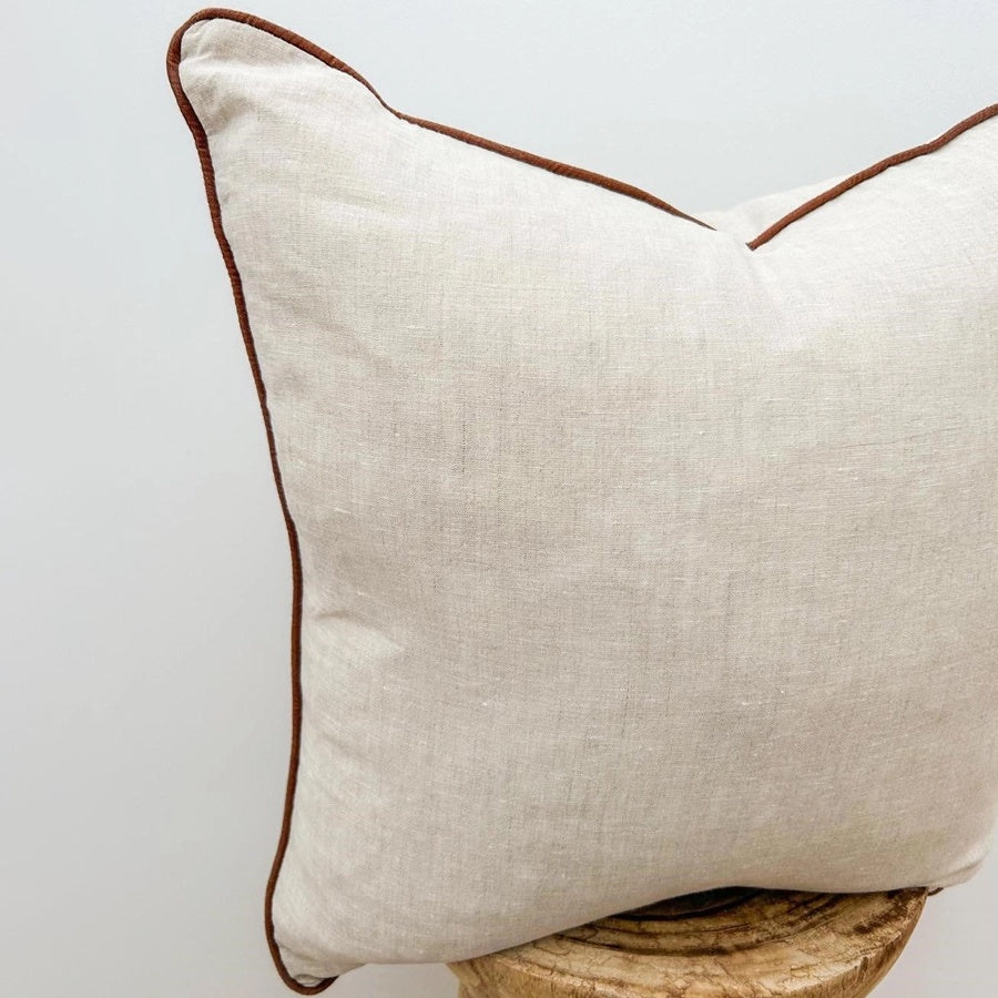 Linen cushion with piped edge in natural