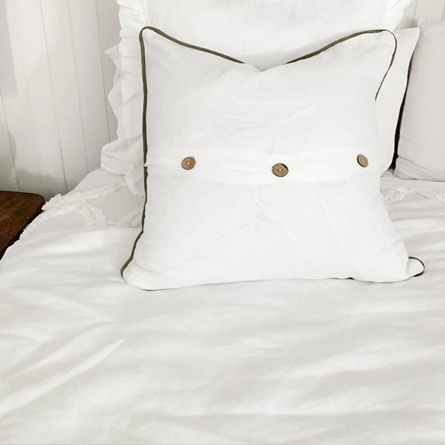 Linen cushion with piped edge in white