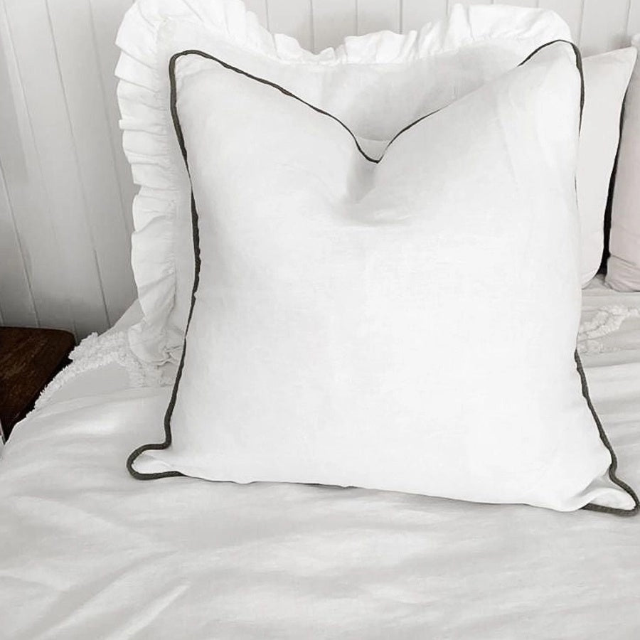 Linen cushion with piped edge in white